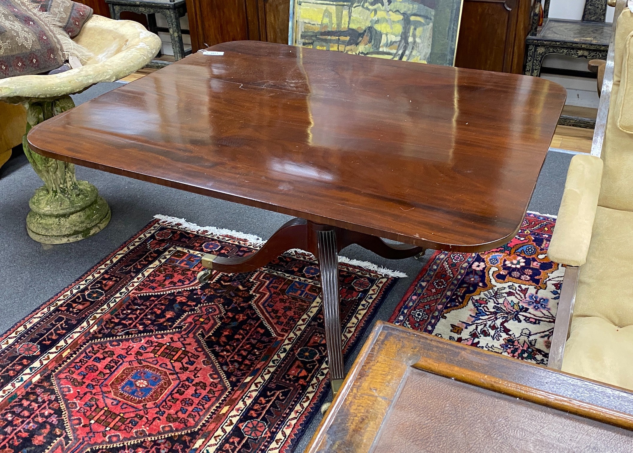 A Regency rectangular mahogany snap top breakfast table on brass casters, width 128cm depth 109cm height 70cm